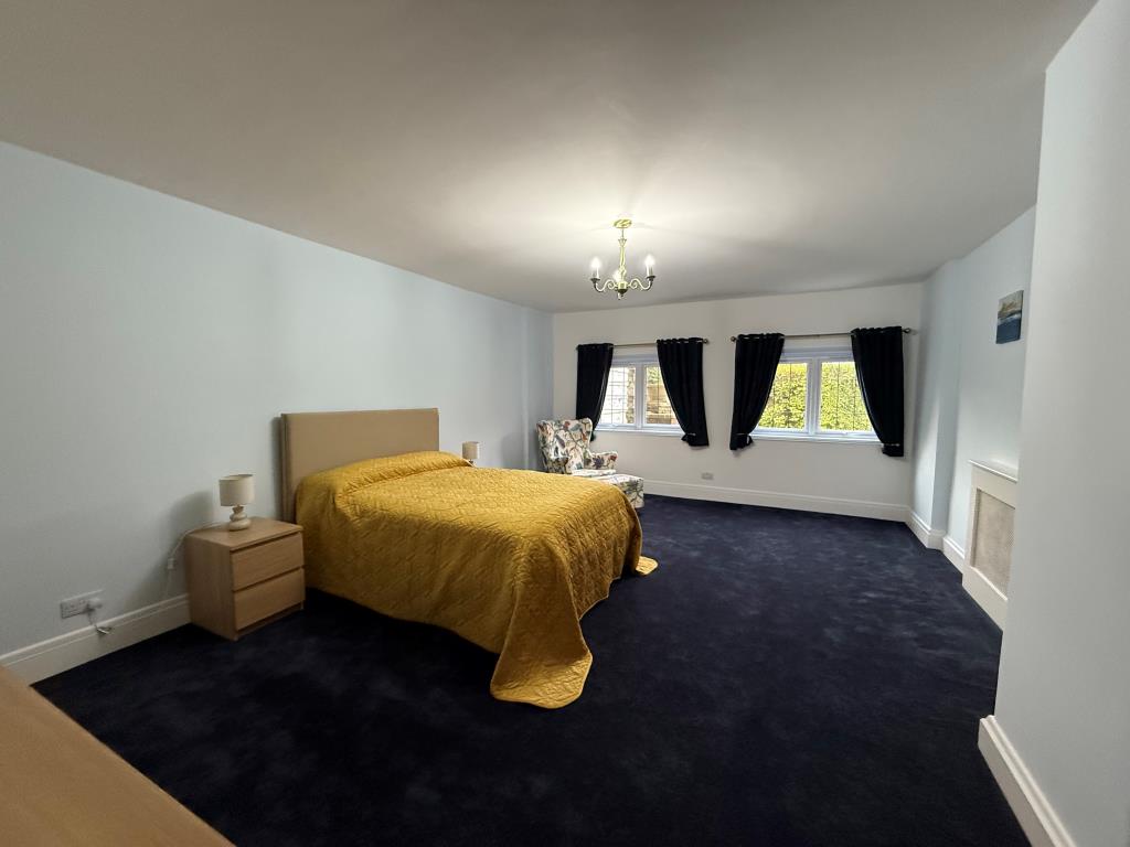 Lot: 59 - NEWLY REFURBISHED TWO-BEDROOM FLAT IN COASTAL LOCATION - Carpeted bedroom with two windows and heaters